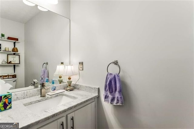 bathroom featuring vanity and toilet