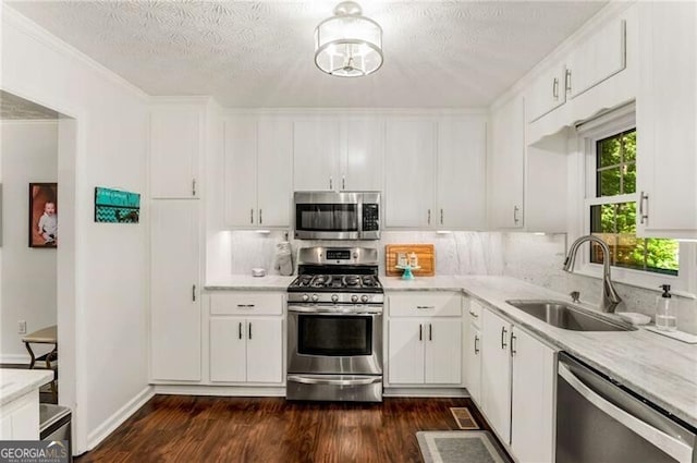 kitchen featuring dark wood-type flooring, sink, white cabinets, and stainless steel appliances