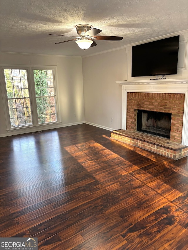 unfurnished living room with ceiling fan, dark hardwood / wood-style flooring, and a brick fireplace