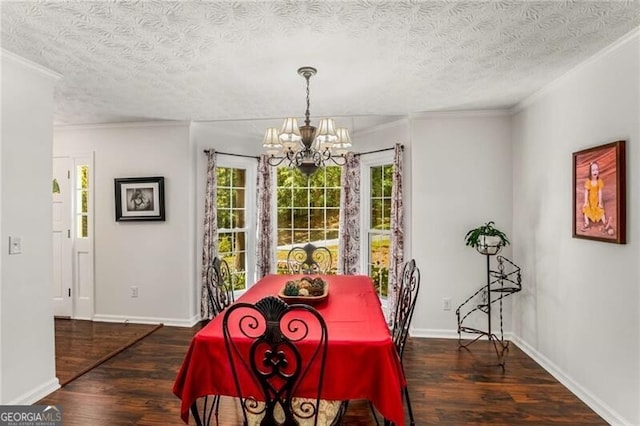 dining room with a textured ceiling, a notable chandelier, ornamental molding, and dark wood-type flooring