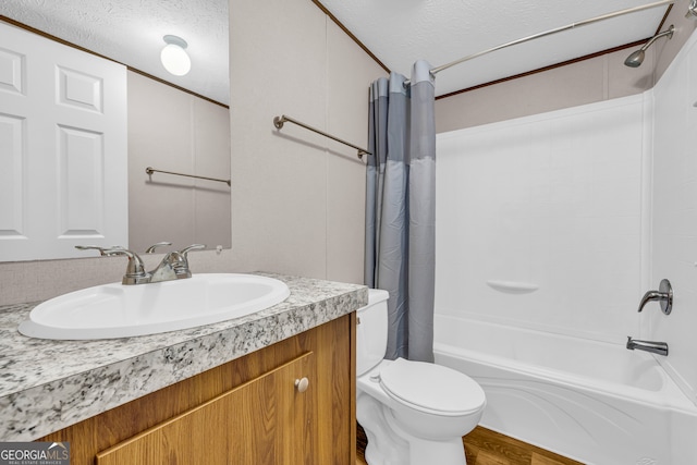 full bathroom featuring a textured ceiling, shower / bath combo, hardwood / wood-style floors, toilet, and vanity