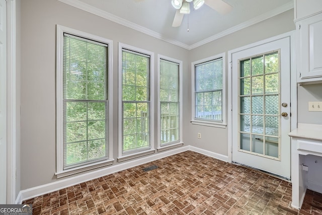 doorway to outside with ornamental molding and ceiling fan