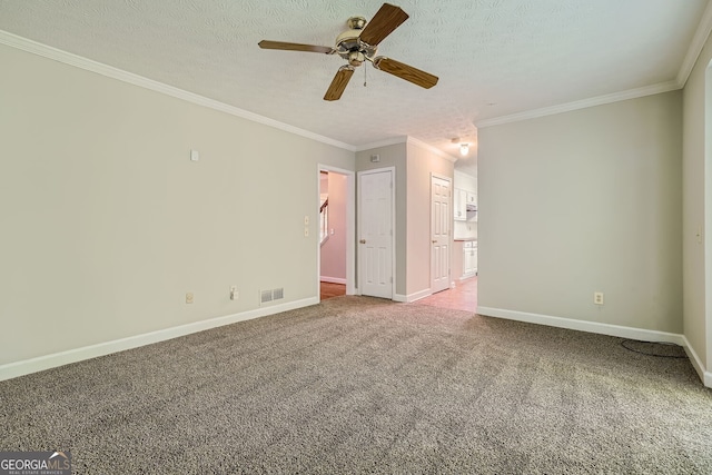 carpeted empty room with ornamental molding, a textured ceiling, and ceiling fan