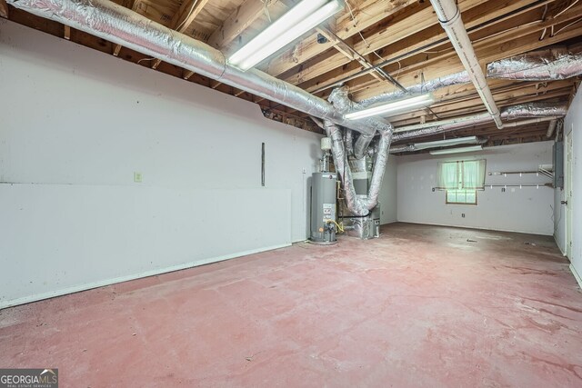 basement featuring water heater and heating unit