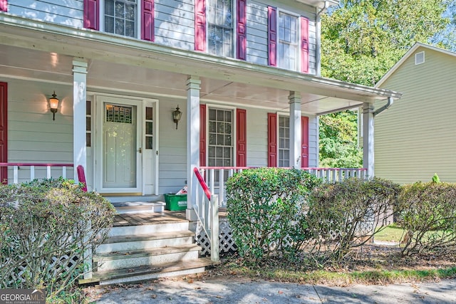 view of exterior entry with a porch