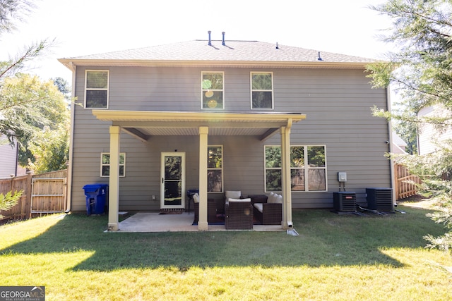 back of house featuring central AC, an outdoor living space, a patio area, and a lawn