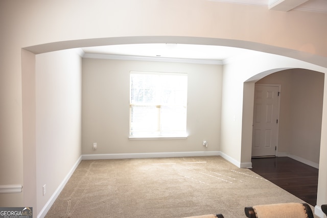 unfurnished room featuring hardwood / wood-style flooring and ornamental molding