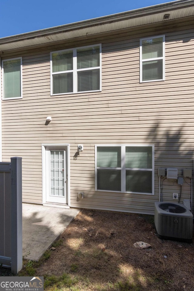 rear view of house with a patio area and cooling unit