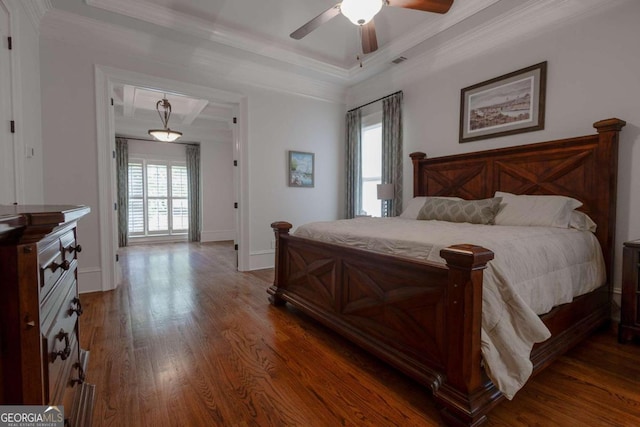 bedroom with ceiling fan, a raised ceiling, ornamental molding, and dark hardwood / wood-style floors