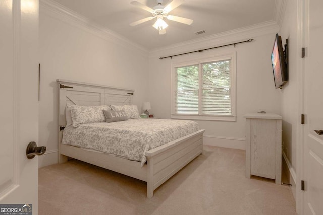 carpeted bedroom with crown molding and ceiling fan