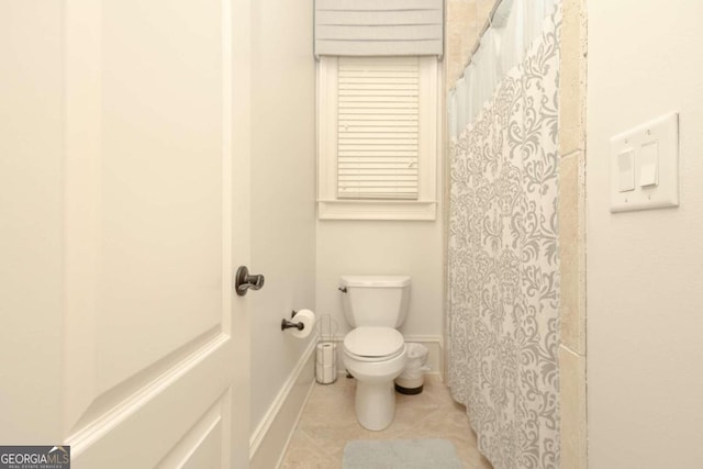 bathroom featuring toilet and tile patterned floors