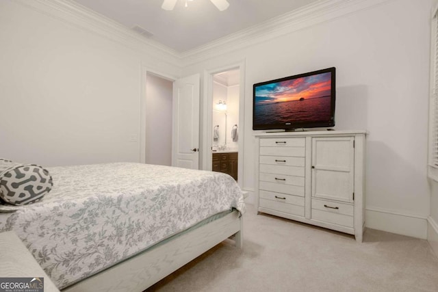 bedroom with ornamental molding, ensuite bathroom, light colored carpet, and ceiling fan