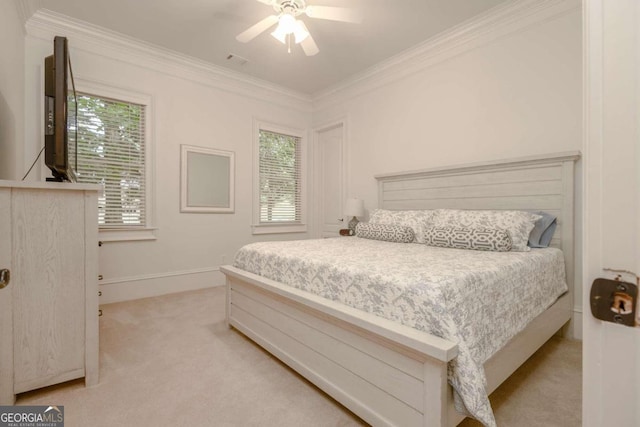 carpeted bedroom with multiple windows, ornamental molding, and ceiling fan