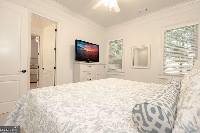 bedroom with multiple windows, ornamental molding, and ceiling fan