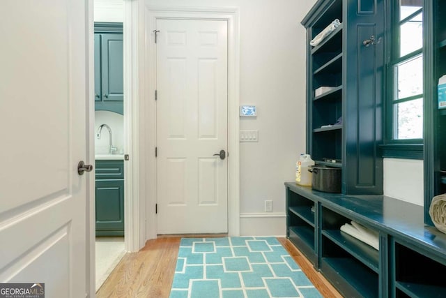 mudroom with wood-type flooring and sink