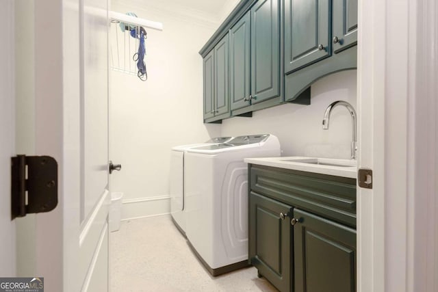 laundry room with washing machine and dryer, sink, cabinets, and ornamental molding