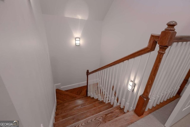 stairs featuring hardwood / wood-style flooring