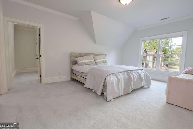 bedroom with lofted ceiling, light carpet, and ornamental molding