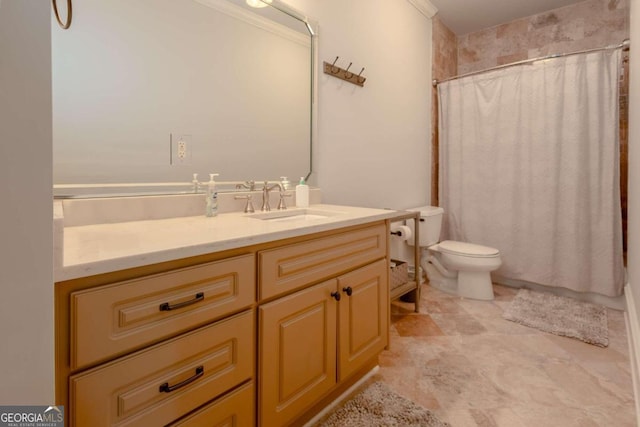 bathroom with toilet, ornamental molding, and vanity