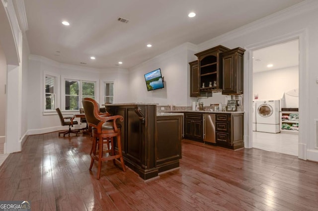 bar with crown molding, washer / clothes dryer, dark brown cabinetry, and dark hardwood / wood-style floors