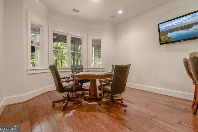 dining area featuring light hardwood / wood-style floors and ornamental molding