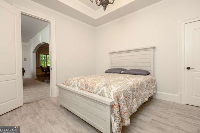 bedroom featuring light hardwood / wood-style floors and ornamental molding