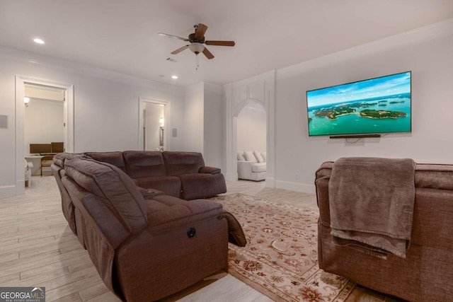 living room with ceiling fan, crown molding, and light hardwood / wood-style floors