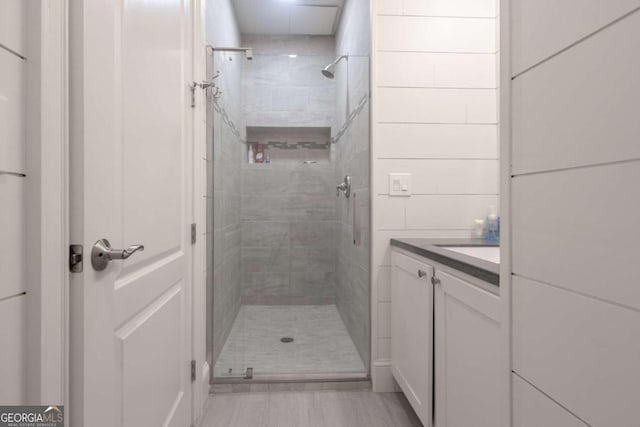 bathroom with vanity and a shower with shower door