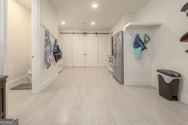 mudroom with washer and dryer and light hardwood / wood-style floors