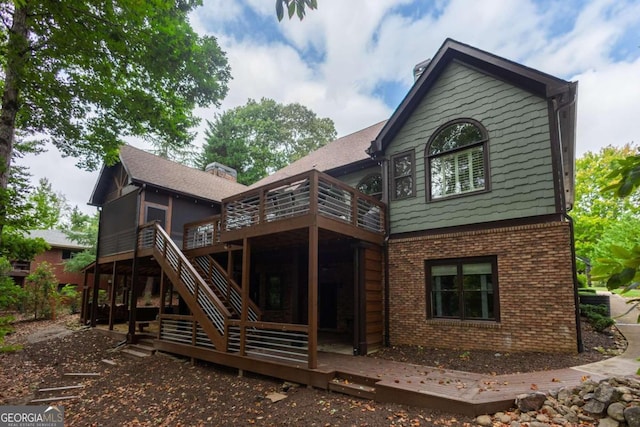 back of property with a wooden deck