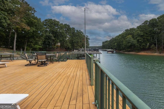 wooden terrace featuring a water view