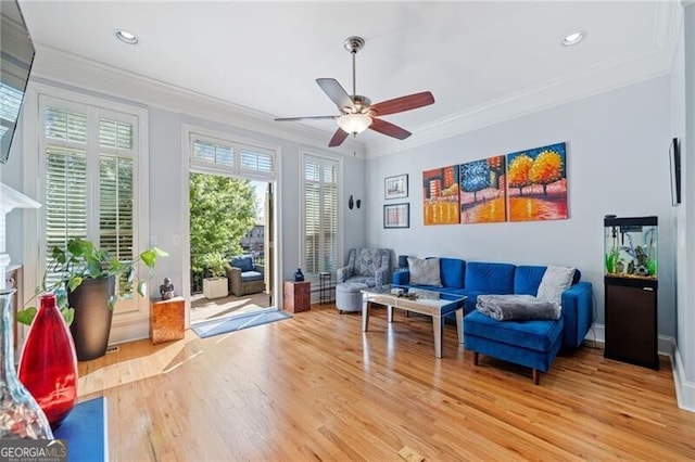 living area featuring crown molding, hardwood / wood-style floors, and a wealth of natural light