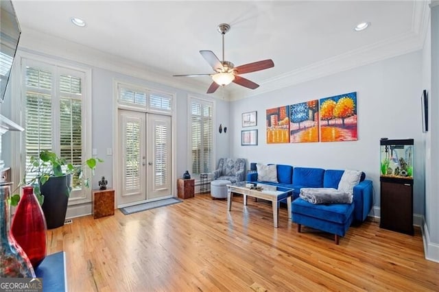 sitting room with ornamental molding, light wood-type flooring, a healthy amount of sunlight, and ceiling fan