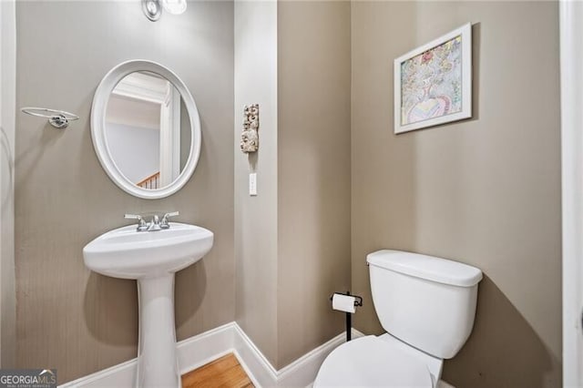 bathroom with sink, hardwood / wood-style flooring, and toilet