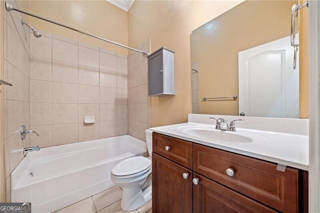 full bathroom featuring tiled shower / bath, vanity, toilet, and tile patterned floors