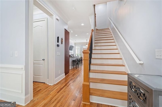 staircase with hardwood / wood-style flooring