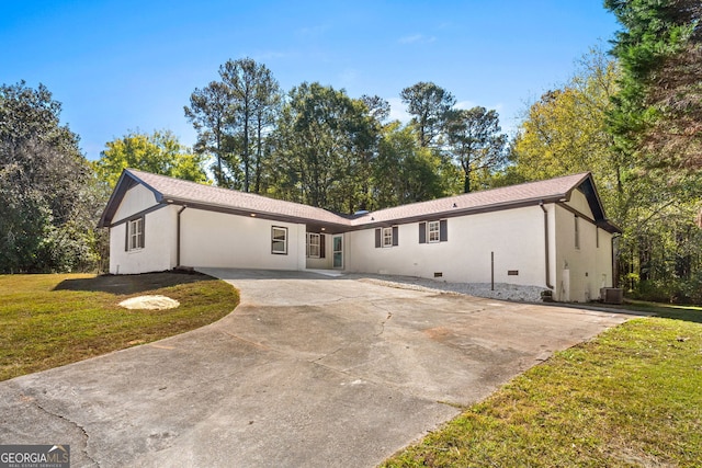 view of front of house with central AC unit and a front yard