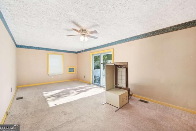 carpeted empty room with a textured ceiling and ceiling fan