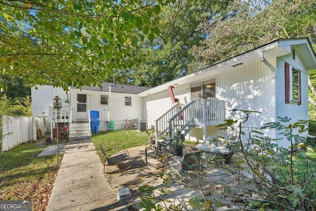 back of property with a patio and central AC