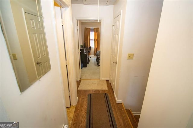 corridor with light hardwood / wood-style floors