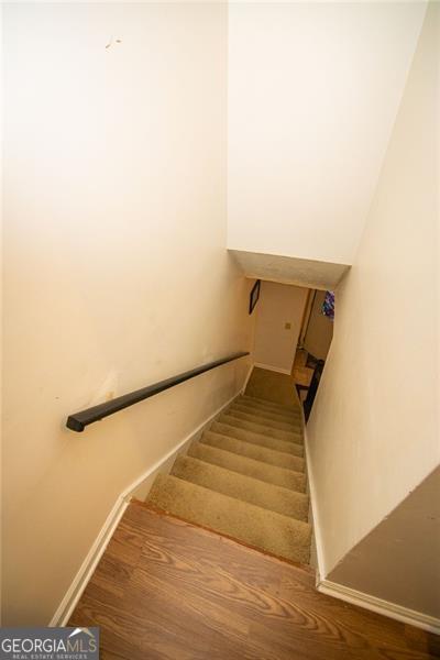 stairs with hardwood / wood-style flooring