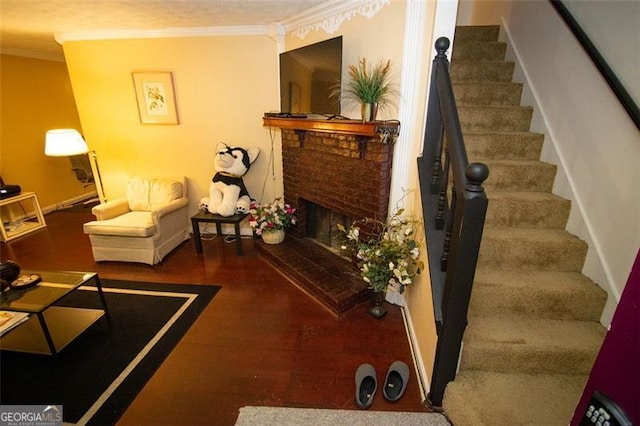 living room with ornamental molding, hardwood / wood-style flooring, and a fireplace