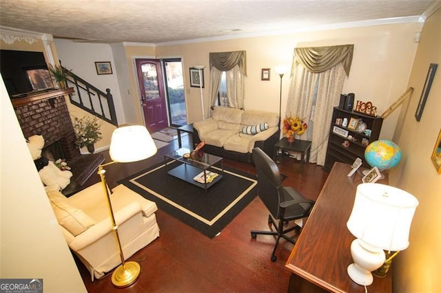 living room with crown molding, a fireplace, and a textured ceiling