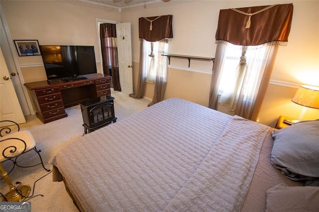 bedroom featuring crown molding and light carpet