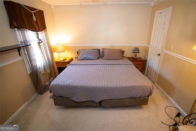 bedroom featuring ornamental molding and carpet floors