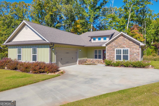 view of front of property with a garage and a front lawn