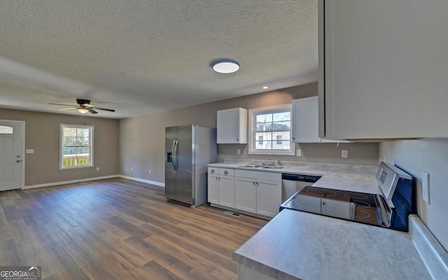 kitchen featuring sink, white cabinets, stainless steel appliances, and a healthy amount of sunlight