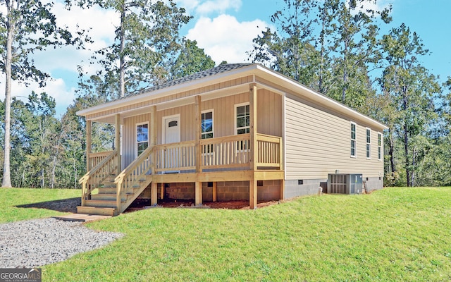 view of front facade with a front yard, central air condition unit, and a porch