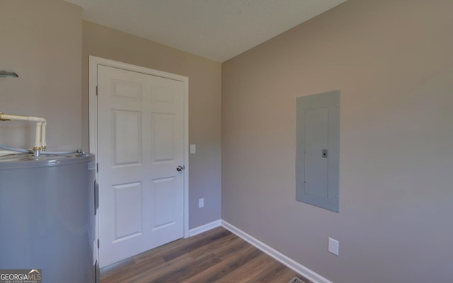 interior space featuring water heater, electric panel, and hardwood / wood-style floors