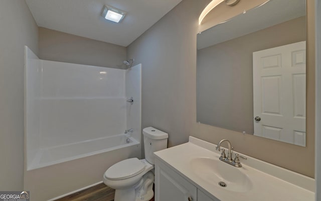 full bathroom with vanity, toilet, hardwood / wood-style flooring, and shower / washtub combination